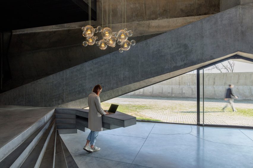 Concrete Facade and a Freen Roofs