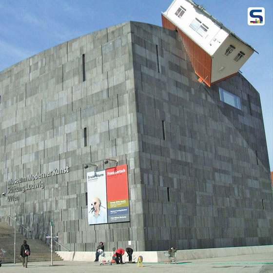 Seems like a hut fallen from the sky and bombarded into the museum, this cottage-sized house in an insecure position on the side of Museum Moderner Kunst (MUMOK)