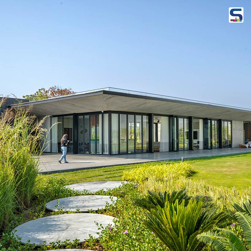 Living Area Transforms Into A Huge Gathering Space In This Glass and Exposed Concrete Gujarat Home | Studio 2+2