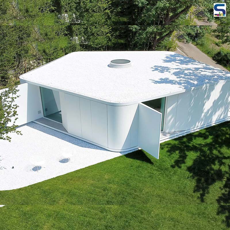 Designed by Milan studio JM Architecture, this holiday home in Italy is covered with glossy white concrete panels with a pentagonal plan.